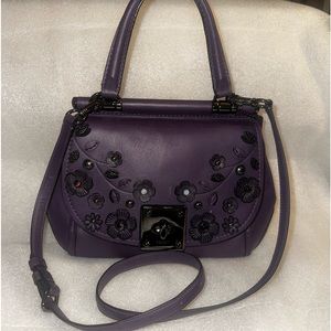 Coach Rare Drifter with Floral appliqué. In the color purple. Beautiful